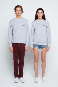 Couple wearing the same grey sweatshirts standing